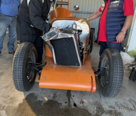 Several regularity competitors and their crew looking at Andrew and Rachael Brown's car to see if they can repair it before Andrew is released from hospital.