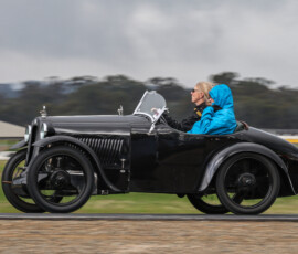 Getting ready for some cornering g-forces as Marilyn is shown how much fun a stolen Austin 7 can be
